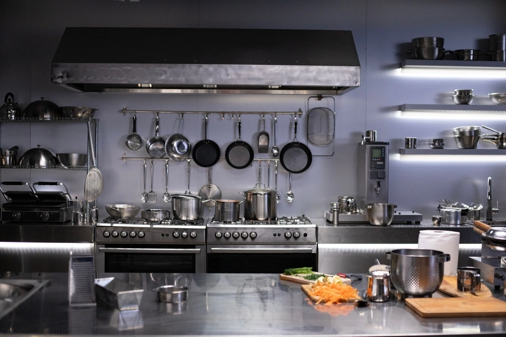 Interior of restaurant kitchen with professional utensils, out of focus